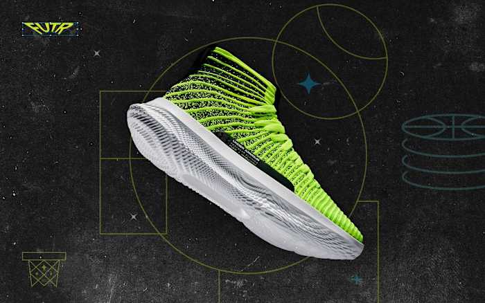 Side view of a yellow and white Under Armour basketball shoe.